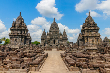 Fototapeta premium View of the Sewu temple complex under a blue sky with clouds. The Sewu temple is the second largest Buddhist temple of Indonesia and is located near the famous Prambanan temple. Java, Indonesia.