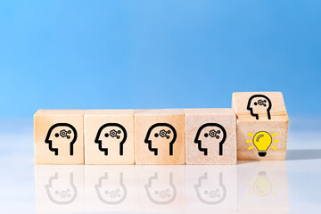 Flip over wooden cube block with head human symbol and light bulb icon revealing the idea. Concept...