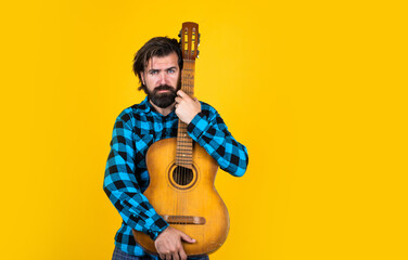 mature singer musician. bearded man with acoustic guitar. brutal guy play the guitar. casual male guitarist. handsome hipster play country music. party string instrument player. copy space