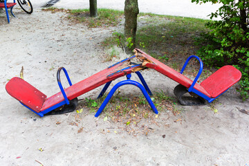 A children's swing is broken in half by vandals.