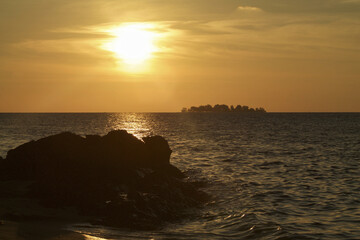 Fototapeta na wymiar tropical seascape with small island on the horizon