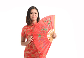 Asian woman in chinese dress holds a big red fan on Chinese New Year.