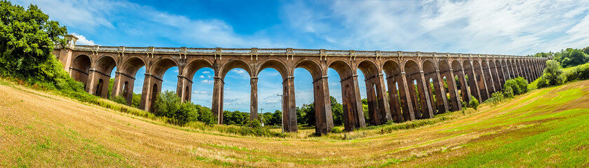 Fototapeta na wymiar A panorama view from a field beside the Ouse Valley viaduct in Sussex, UK on a summers day