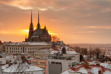 Aerial view of the The Cathedral of Saints Peter and Paul in Brno in Czech Republic. Long exposure, used neutral density filter at winter sunrise time . View from Spilberk Castle  - obrazy, fototapety, plakaty