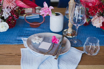 Coziness and style. Modern event design. Table setting at wedding reception. Floral compositions...