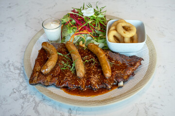 Pork Ribs Steak, Smoked hot dog, fragrant, deep fried And salad vegetables on the plate