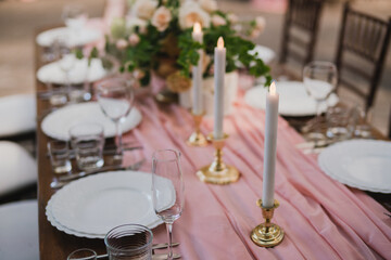 Coziness and style. Modern event design. Table setting at wedding reception. Floral compositions...