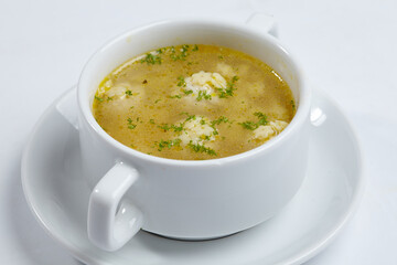 soup with meatballs on white dish