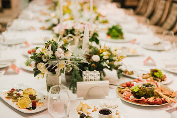 Catering banquet table at wedding reception. Restaurant presentation, european cuisine, food consumption, party concept. Food styling, appetizers bar, welcome drink, event design.