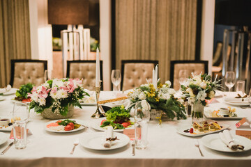 Catering banquet table at wedding reception. Restaurant presentation, european cuisine, food consumption, party concept. Food styling, appetizers bar, welcome drink, event design.