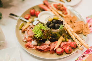 Catering banquet table at wedding reception. Restaurant presentation, european cuisine, food consumption, party concept. Food styling, appetizers bar, welcome drink, event design.