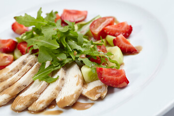 chicken fillet with salad and strawberries