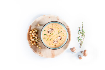 Delicious mushroom cream soup with champignons isolated on white background