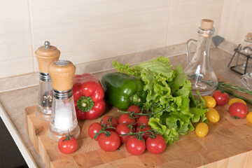 Fresh vegetables on wooden table in kitchen