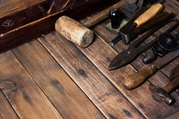 Fototapeta na wymiar Old carpenter hand tools on wooden plank background