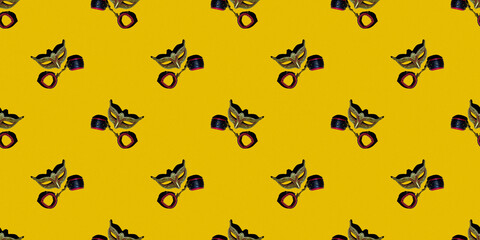 Classic Venetian theater mask with leather toy handcuffs isolated on a yellow pixel background. Seamless texture of a repeating pattern. The concept of adult Wallpaper for design.
