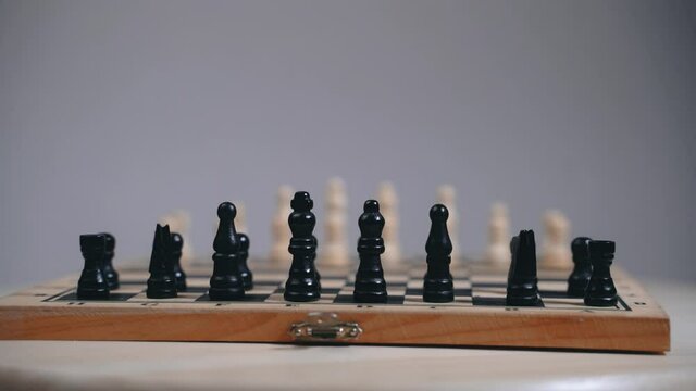 Chess board with exposed pieces, spinning board movement, gray background