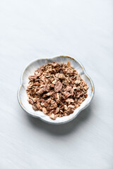 Dry root of Rhodiola rosea. Golden root, rose root. Healthy medical plant on wooden background. Close up. 