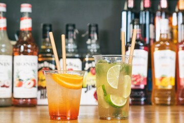 Cold ice beverage alcohol drink with fruits. Drikk with lemon and orange and ice.