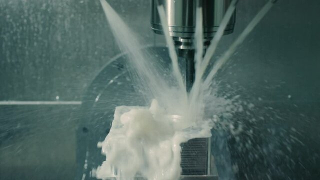 Mold machine drills and sprays water on mold as it's made in manufacturing plant