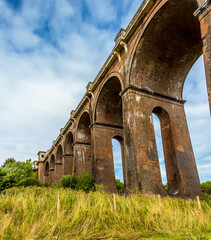 The view looking uphill towards the northern end of the Ouse Valley viaduct in Sussex, UK on a summers day