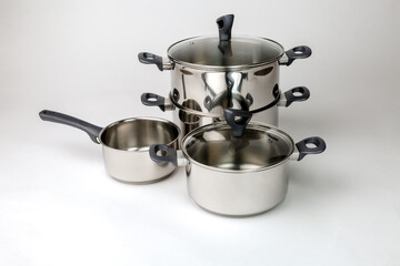 Stainless steel pots and pans for induction panel, insulated on white background
