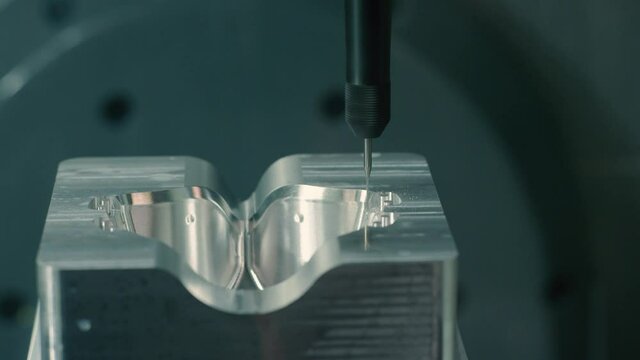 Mold machine drills and sprays water on mold as it's made in manufacturing plant