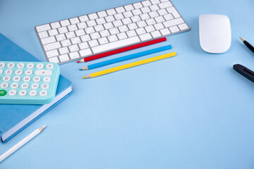 calculator on notebook with pencils and keyboard
