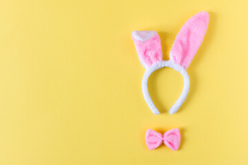 Costume bunny ears top view on yellow background.