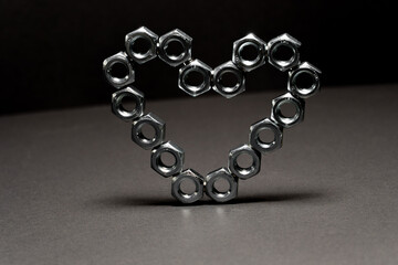 Heart shape made of hex bolts. Creative love concept