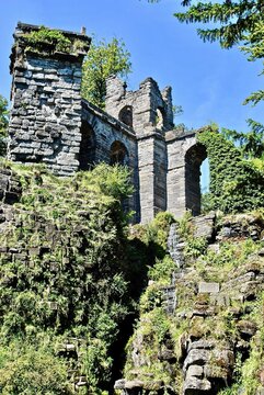 Artificial ruins of a Roman aqueduct. Photo taken at Bergpark "mountain park" Wilhelmshohe in Kassel, Germany. This park has been a UNESCO World Heritage Site since 2013. 