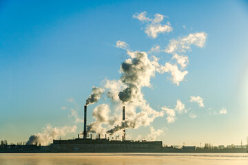 Smoke stacks with smoke emission. Plant pipes pollute atmosphere. Industrial factory pollution,...
