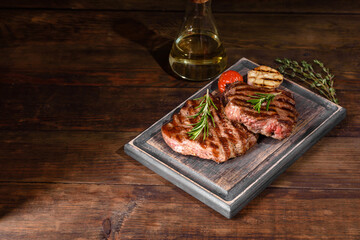 Fresh juicy delicious beef steak on a dark background