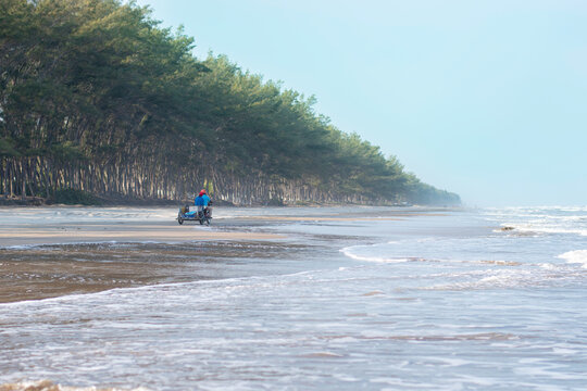 young woman enjoying on the river bank with the sea in the background