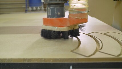 The CNC machine is working. Close-up of a numerical control machine cuts a tree. CNC tool. The...