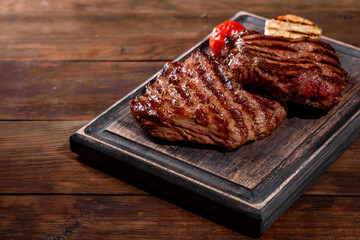 Fresh juicy delicious beef steak on a dark background