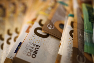 Bundled euro banknotes with selective focus - obrazy, fototapety, plakaty