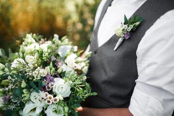 Wedding bouquet in the hands of a man.
