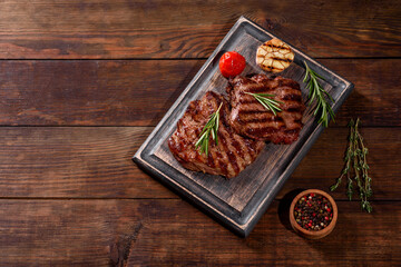 Fresh juicy delicious beef steak on a dark background