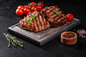 Fresh juicy delicious beef steak on a dark background