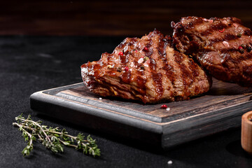 Fresh juicy delicious beef steak on a dark background