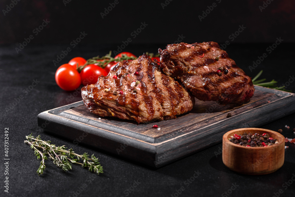 Wall mural fresh juicy delicious beef steak on a dark background