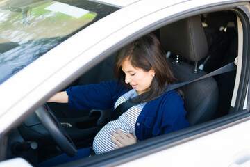 Pregnant woman with contractions driving to the hospital