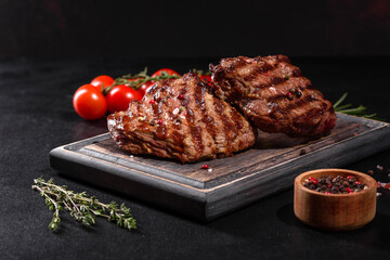Fresh juicy delicious beef steak on a dark background