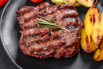Fresh juicy delicious beef steak on a dark background