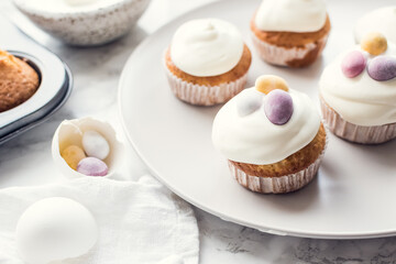 Glazed Easter cupcakes decorated with mini chocolate eggs