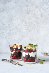 Dessert black forest in a glass on a light concrete background. Traditional German dessert. Black Forest cake.