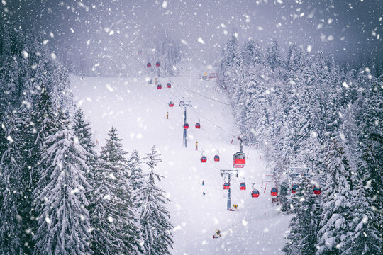 Postavaru mountain with ski slopes and cable car transporting in Poiana Brasov, Romania
