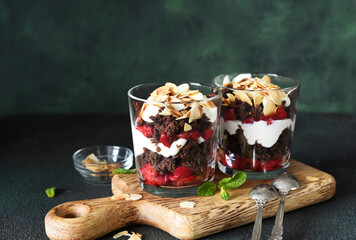 Dessert black forest with cherries in a glass on a wooden board. Traditional German dessert.
