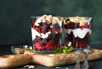 Dessert black forest with cherries in a glass on a wooden board. Traditional German dessert.